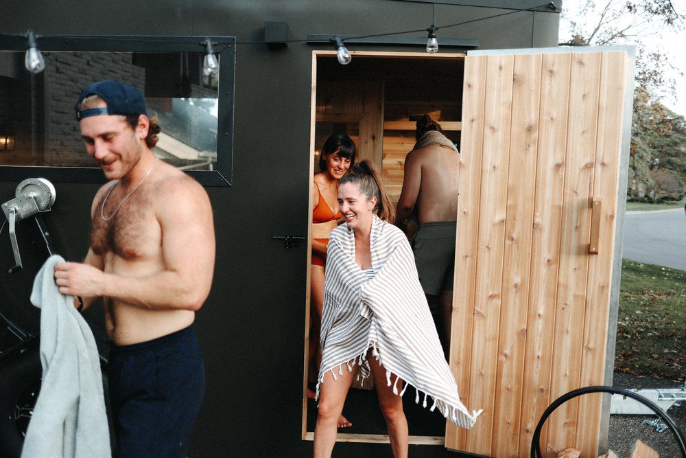 group getting out of the very hot sauna at a minneapolis sauna event